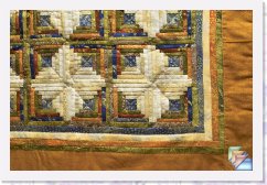 Log Cabin * Gold Leaf Log CabinThis is a mini quilt that measures 34 x 34 in. This creation took me months to put together,with little bits of fabrics in each log cabin. The fabrics are original prints from Australia withdifferent colors, like green, beige, orange, blue, brown, with a nice detail of gold color in each fabric with the representation of native animals.The border of the quilt is like a brown red desert color with little details of gold color matchingthe other fabrics. I will describe this quilt like a Royal desert quilt. This is a unique design.This quilt is dry cleaning only. It is a piece of art reflected on a quilt. The backing of this quilt isbeige calico. This quilt has been machine quilted and hand quilted. Available for purchase at $200.00 * (9 Slides)